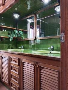 a bathroom with two sinks and a mirror at Villa Alella in Alella