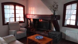 a living room with a fireplace and a couch at Villa Alella, 5 bedrooms & pool in Alella