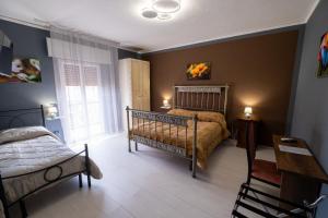a bedroom with a bed and a window at Room 112 Oltremare in Bagheria