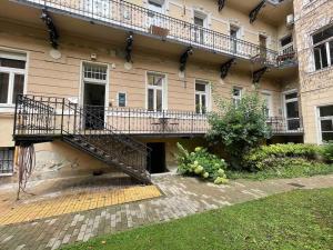 a building with a staircase on the side of it at Knézits Spacious AC Terrace Free Parking in Budapest