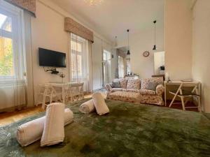 a living room with a couch and a table at Knézits Spacious AC Terrace Free Parking in Budapest
