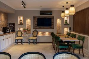 a dining room with tables and chairs and a tv at Lagun Palas in Yalova