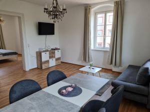 a living room with a table and chairs and a couch at Traumhafter Altbau im Herzen Schwertbergs in Schwertberg
