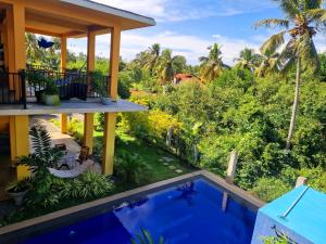a view of a resort with a swimming pool at Nature Paradise Guesthouse in Wayikkal