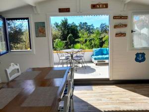 a dining room with a table and chairs and a patio at Charming House in Figueira da Foz with Private Garden in Figueira da Foz