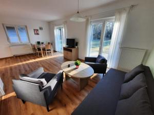 a living room with a couch and a table at Seepark Wolfswinkel in Storkow