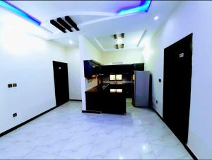 a room with black doors and a white tile floor at Galaxy Inn Guest House in Karachi