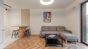 a living room with a couch and a table at Apartamenty Sun & Snow Belnihel in Hel