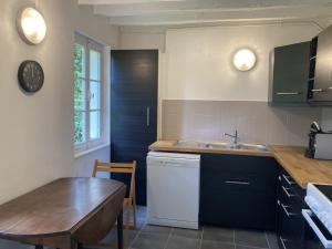a kitchen with a table and a sink and a counter at LIf in Varengeville-sur-Mer