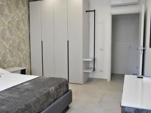 a bedroom with a bed and a closet and a door at Apartment Brezza di Mare by Interhome in Formia