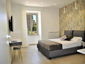 a bedroom with a bed and a desk and a window at Apartment Brezza di Mare by Interhome in Formia