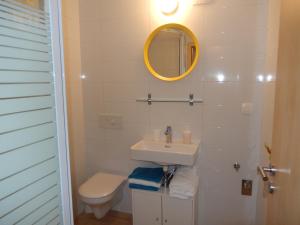 a bathroom with a sink and a toilet and a mirror at Villa Šiša in Primošten +46 photos
