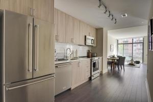 a kitchen with stainless steel appliances and a dining room at Bethesda 1br w gym concierge nr metro station WDC-807 in Bethesda