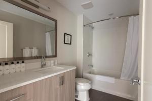 a bathroom with a sink and a toilet and a mirror at Bethesda 1br w gym concierge nr metro station WDC-807 in Bethesda +21 photos