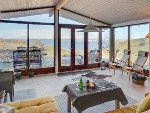 a living room with a view of the ocean at Holiday Home Geeske - 150m from the sea in Funen by Interhome in Middelfart