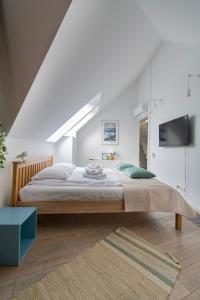 a bedroom with a large bed in a white room at Duplex apartment in the center of Krakow in Krakow