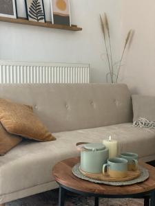 a living room with a couch and a table with a candle at Kajüthus Apartment 4 in Fehmarn