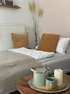 a bedroom with a bed and a table with candles at Kajüthus Apartment 4 in Fehmarn
