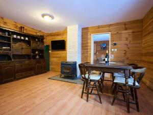 a dining room with a table and a stove at Holiday Home Chaloupka U lesa by Interhome in Harrachov