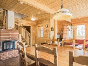 a dining room and living room with a fireplace at Holiday Home Koparanperä by Interhome in Kakslauttanen