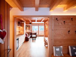 a kitchen and living room with wooden walls at Chalet Chalet les Pars by Interhome in Gryon