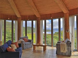 a living room with couches and chairs and windows at 1 Bed in Acharacle CA368 in Kilchoan