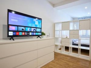 a large flat screen tv on a white wall in a room at Apartment U Dzina-1 by Interhome in Polubný +36 photos