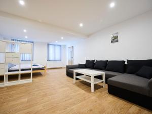 a living room with a couch and a table at Apartment U Dzina-1 by Interhome in Polubný
