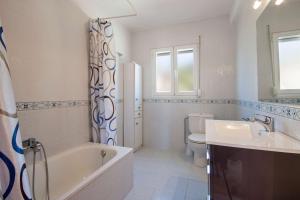 łazienka z wanną, toaletą i umywalką w obiekcie Villa Carola - PlusHolidays w mieście Calpe