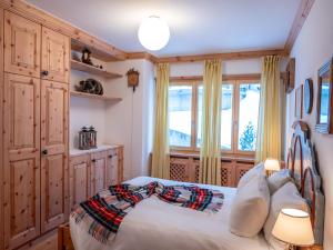 a bedroom with a bed and a window at Apartment Chesa Arlas C4 by Interhome in St. Moritz