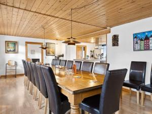 a dining room with a wooden table and chairs at Holiday Home Sune - 6km from the sea in NW Jutland by Interhome in Thisted