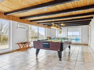 a living room with a pool table and windows at Holiday Home Sune - 6km from the sea in NW Jutland by Interhome in Thisted
