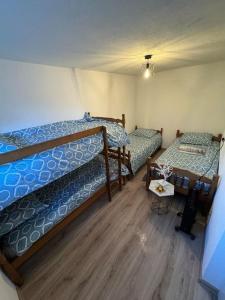 a bedroom with two bunk beds and a table at Romantična vikendica in Pale