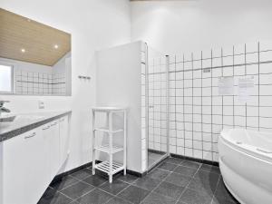 een badkamer met een toilet, een wastafel en een plank bij Holiday Home Rudy - 800m from the sea in NW Jutland by Interhome in Løkken