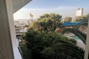 a view from the balcony of a building with palm trees at Embassy Apartment in Cape Town
