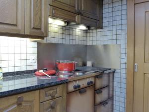 a kitchen with a stove with a pot on it at Holiday Home Chalet Zun by Interhome in Sarnen