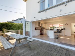 a patio with a picnic table and a kitchen at 5 Bed in Mortehoe 76593 in Mortehoe