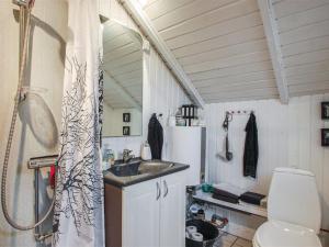 een badkamer met een douche, een wastafel en een toilet bij Holiday Home Anu - 400m from the sea in SE Jutland by Interhome in Aabenraa