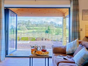 a living room with a couch and a large sliding glass door at 2 Bed in Bewdley 77721 in Highley