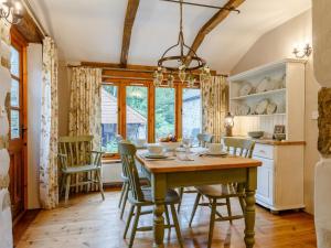 a dining room with a wooden table and chairs at 3 Bed in Polyphant 78210 in Trewen