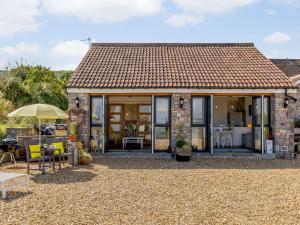 a cottage with glass doors and a patio at 1 Bed in Weston-Super-Mare 78986 in Weston-super-Mare