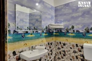 a bathroom with a sink and a mural on the wall at StayVista's Palm Perle Villa - Pet-Friendly Retreat with Terrace & Lawn in Bhopal +11 photos