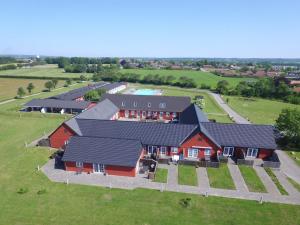 an overhead view of a large red house with black roofs at Holiday Home Thorulf - 6km from the sea in Bornholm by Interhome in Åkirkeby