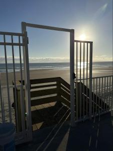 an open door to a beach with the ocean at OCEAN FRONT Condo On The Beach in Daytona Beach +1 photo