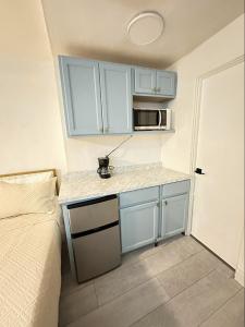 a small kitchen with a sink and a microwave at OCEAN FRONT Condo On The Beach in Daytona Beach
