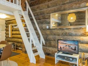 uma sala de estar com uma televisão e uma parede de madeira em Holiday Home Auroora by Interhome em Sirkka