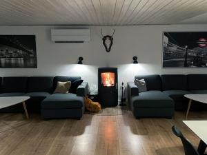 a living room with couches and a fire place at Holiday Home Keti - 50m from the sea in NE Jutland by Interhome in Hadsund
