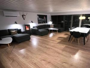 a living room with a couch and a table at Holiday Home Keti - 50m from the sea in NE Jutland by Interhome in Hadsund