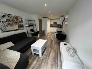 a living room with a couch and a table at Stylish 1-Bed Flat with Sofa-Bed in London in London