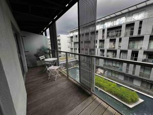 a balcony with a table and chairs on a building at Stylish 1-Bed Flat with Sofa-Bed in London in London